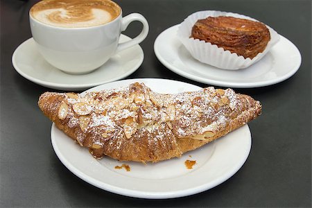 Almond Croissant French Pastry on White Plate with Cup of Latte Stock Photo - Budget Royalty-Free & Subscription, Code: 400-06798926