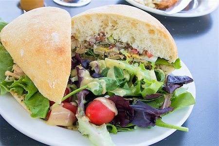 simsearch:400-06798929,k - Tuna Salad Sandwich with Ciabatta Bread and Leafy Mixed Green Salad with Tomatoes Stock Photo - Budget Royalty-Free & Subscription, Code: 400-06799174