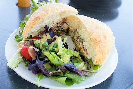 simsearch:400-06798929,k - Tuna Salad Sandwich with Ciabatta Bread and Leafy Mixed Green Salad with Tomatoes Closeup Stock Photo - Budget Royalty-Free & Subscription, Code: 400-06799173