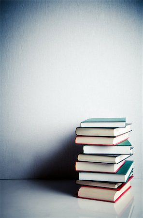 simsearch:400-05145983,k - Stack of red, green and black books on white reflective surface Stock Photo - Budget Royalty-Free & Subscription, Code: 400-06799181