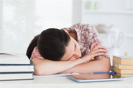 Brunette leaning on the table next to books in kitchen Stock Photo - Budget Royalty-Free & Subscription, Code: 400-06799449