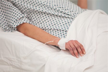 patient on bed and iv - Arm of young woman attached to intravenous drip Stock Photo - Budget Royalty-Free & Subscription, Code: 400-06799557
