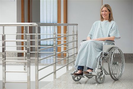 paraplegic women in wheelchairs - Smiling woman wearing hospital gown sitting in wheelchair in hospital corridor Stock Photo - Budget Royalty-Free & Subscription, Code: 400-06799579