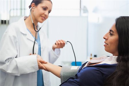 Patients blood pressure being checked by doctor in hospital room Stock Photo - Budget Royalty-Free & Subscription, Code: 400-06799648