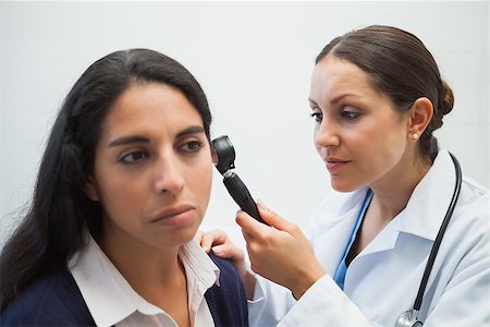 simsearch:400-06875952,k - Doctor is looking into the ear of the woman with an instrument Stockbilder - Microstock & Abonnement, Bildnummer: 400-06799650