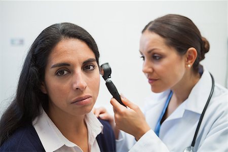 simsearch:400-06875952,k - Patients ear being checked by doctor using otoscope in hospital Stockbilder - Microstock & Abonnement, Bildnummer: 400-06799651