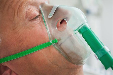 Man wearing oxygen mask in hospital Stock Photo - Budget Royalty-Free & Subscription, Code: 400-06799661