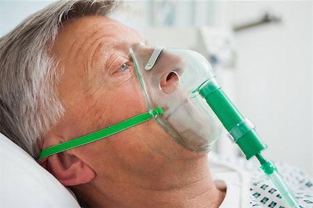 Man in bed with oxygen mask in hospital Stock Photo - Budget Royalty-Free & Subscription, Code: 400-06799662