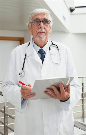 Doctor holding file in hospital corridor Stock Photo - Budget Royalty-Free & Subscription, Code: 400-06799673