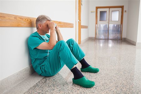 simsearch:400-06734621,k - Doctor sitting on the floor with hands in his face thinking Stock Photo - Budget Royalty-Free & Subscription, Code: 400-06799711