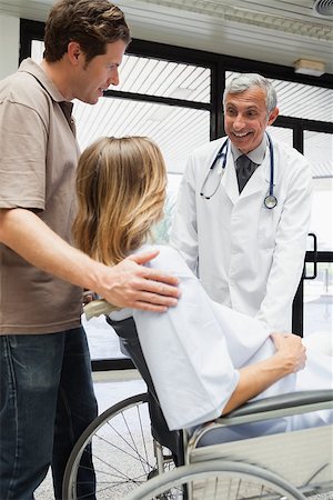 pregnant stethoscope - Doctor talking with pregnant woman in wheelchair and partner in hospital corridor Stock Photo - Budget Royalty-Free & Subscription, Code: 400-06799758