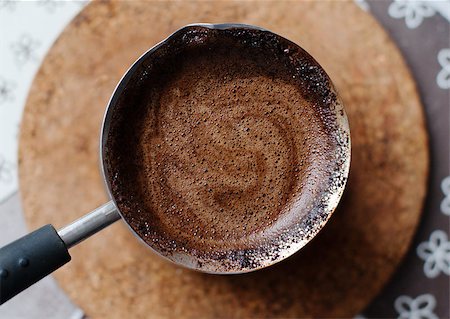 Hot coffee prepared in a Turk. Top view on a beautiful curled Stock Photo - Budget Royalty-Free & Subscription, Code: 400-06790146