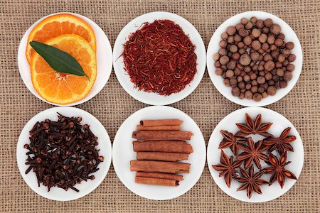 simsearch:400-06327283,k - Sweet spice ingredient selection with sliced orange fruit in white porcelain bowls over white background. Stock Photo - Budget Royalty-Free & Subscription, Code: 400-06790170