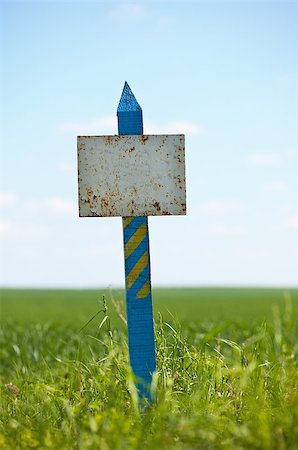 simsearch:400-04420614,k - Weather-beaten sign on a grassy land plot Stock Photo - Budget Royalty-Free & Subscription, Code: 400-06790281