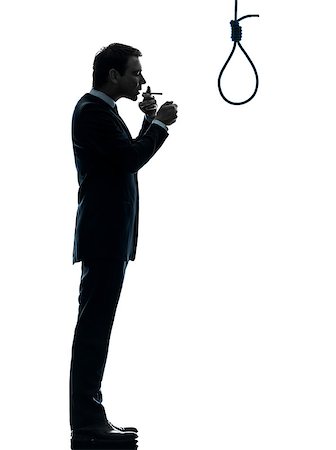 one caucasian man smoking cigarette  standing in front of hangman's noose in silhouette studio isolated on white background Stock Photo - Budget Royalty-Free & Subscription, Code: 400-06790405