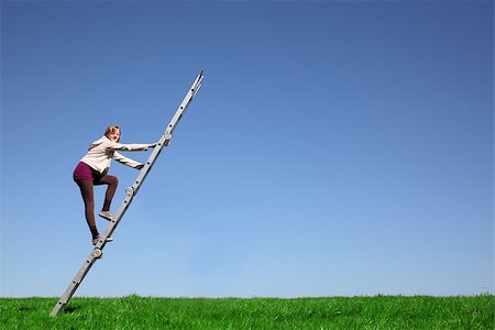 Young girl climbs a ladder on green meadow with blue sky Stock Photo - Budget Royalty-Free & Subscription, Code: 400-06790747