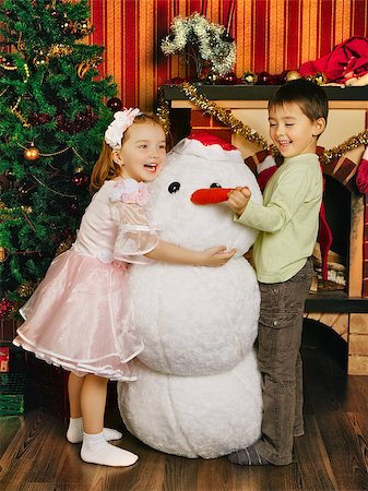 sister hugs baby - two beautiful child and toy snowman near christmas tree Stock Photo - Budget Royalty-Free & Subscription, Code: 400-06790899
