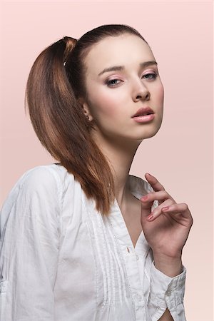 simsearch:400-06790945,k - beauty young girl in sensual pose with brown smooth ponytail hair-style, wearing sexy white shirt Photographie de stock - Aubaine LD & Abonnement, Code: 400-06790945