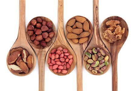 Nut selection in olive wood spoons over white background. Stock Photo - Budget Royalty-Free & Subscription, Code: 400-06790998