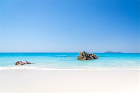 La Digue island, Seyshelles, Anse Source d'Argent. White coral beach sand. Sailing yacht on background. Stock Photo - Budget Royalty-Free & Subscription, Code: 400-06791455