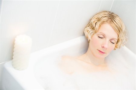 Young woman relaxing in the bath with candlelight Stock Photo - Budget Royalty-Free & Subscription, Code: 400-06792955