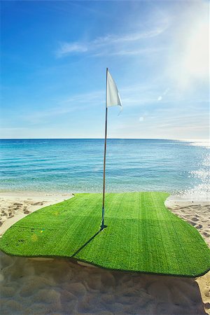 Golf driving range on beach, with sun flare appear Fotografie stock - Microstock e Abbonamento, Codice: 400-06793233