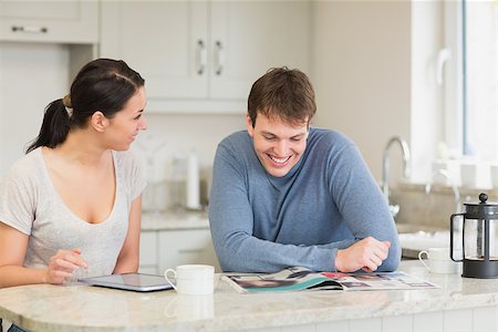 people reading magazines and tablets - Two people sitting in the kitchen having fun are reading and talking Stock Photo - Budget Royalty-Free & Subscription, Code: 400-06800206