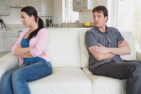 friends home upset - Two people ignore each other while sitting in the living room on the couch Stock Photo - Budget Royalty-Free & Subscription, Code: 400-06800239