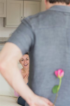 Man hides a flower behind his back to surprise the woman Stock Photo - Budget Royalty-Free & Subscription, Code: 400-06800251