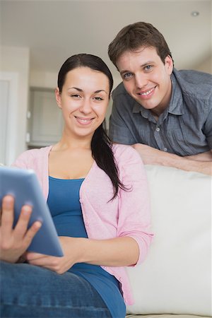 Young couple using a tablet computer and having fun on the couch Stock Photo - Budget Royalty-Free & Subscription, Code: 400-06800274