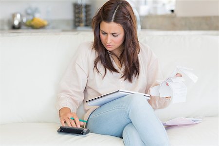 simsearch:400-06803524,k - Woman calculating bills on the sofa Stock Photo - Budget Royalty-Free & Subscription, Code: 400-06801006