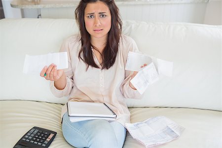 simsearch:400-06803524,k - Woman getting stressed over bills on sofa Stock Photo - Budget Royalty-Free & Subscription, Code: 400-06801009