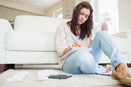 simsearch:400-06803524,k - Young woman working out finances on floor of living room Stock Photo - Budget Royalty-Free & Subscription, Code: 400-06801018