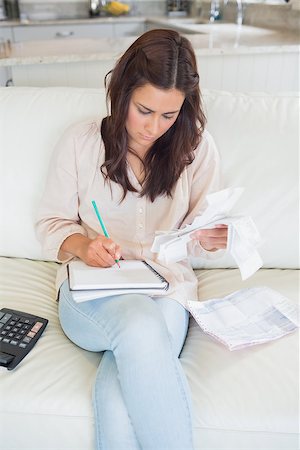 simsearch:400-06803524,k - Woman calculating receipts on sofa Stock Photo - Budget Royalty-Free & Subscription, Code: 400-06801011