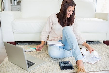 simsearch:400-06803524,k - Woman using laptop to calculate bills on floor of living room Stock Photo - Budget Royalty-Free & Subscription, Code: 400-06801029