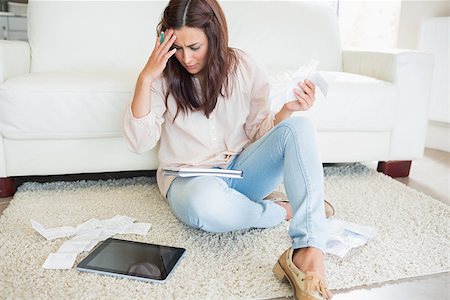 Woman with tablet pc calculating bills on the carpet Stock Photo - Budget Royalty-Free & Subscription, Code: 400-06801022