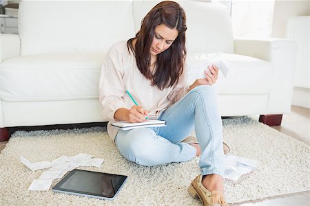 simsearch:400-06803524,k - Young woman adding receipts on floor of living room Stock Photo - Budget Royalty-Free & Subscription, Code: 400-06801023