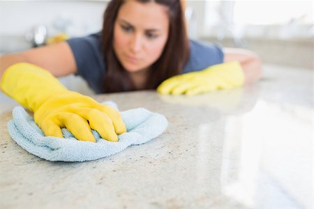 Woman wiping counter in kitchen Stock Photo - Budget Royalty-Free & Subscription, Code: 400-06801094