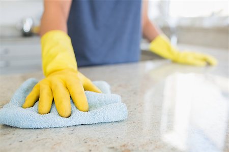 simsearch:6109-08488688,k - Woman cleaning the counter  in the kitchen Stock Photo - Budget Royalty-Free & Subscription, Code: 400-06801093