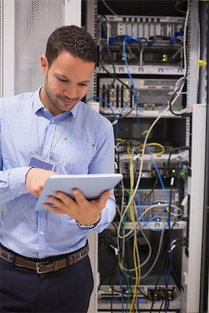 Man in data centre using a  tablet pc Stock Photo - Budget Royalty-Free & Subscription, Code: 400-06801195