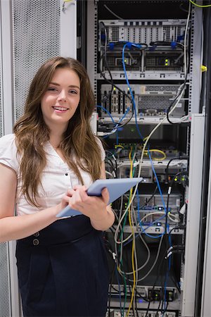 data center tablet - Smiling woman using tablet pc to work on servers in data center Stock Photo - Budget Royalty-Free & Subscription, Code: 400-06801247