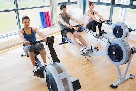 simsearch:400-06801597,k - People using rowing machines in fitness studio Stock Photo - Budget Royalty-Free & Subscription, Code: 400-06801576