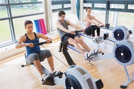 simsearch:400-06801591,k - Three people on rowing machines in fitness studio Stock Photo - Budget Royalty-Free & Subscription, Code: 400-06801578