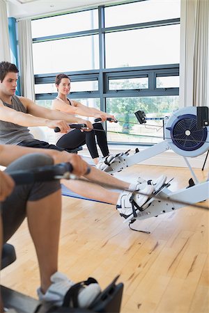 simsearch:400-06801597,k - Woman looking up from rowing machine workout in fitness studio Stock Photo - Budget Royalty-Free & Subscription, Code: 400-06801579