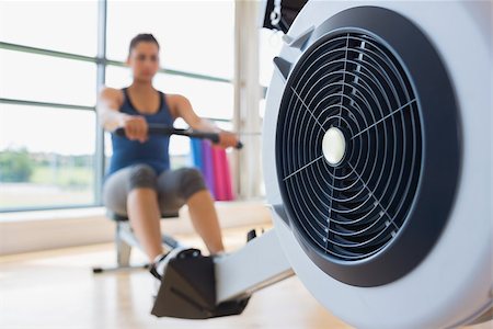 simsearch:400-06801591,k - Rowing machine being used in fitness studio Stock Photo - Budget Royalty-Free & Subscription, Code: 400-06801580