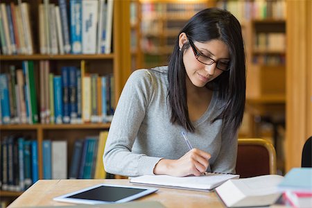 simsearch:400-06803206,k - Black-haired woman studying in the library Stock Photo - Budget Royalty-Free & Subscription, Code: 400-06801606
