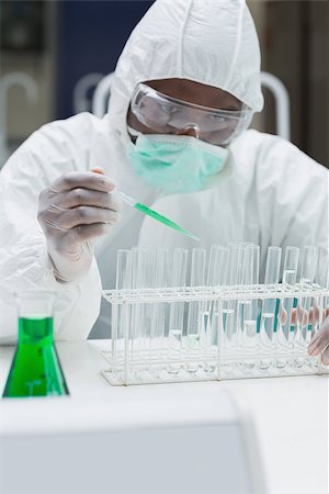 simsearch:6109-07497806,k - Chemist in protective suit adding green liquid to test  tubes in the lab Fotografie stock - Microstock e Abbonamento, Codice: 400-06801692