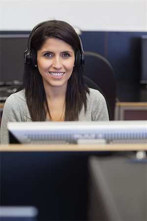 simsearch:400-07267978,k - Smiling woman working in computer room in college Stock Photo - Budget Royalty-Free & Subscription, Code: 400-06801779