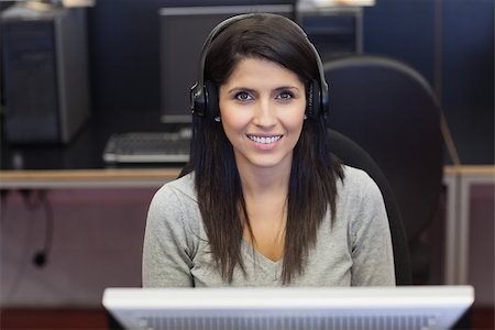 simsearch:400-07267978,k - Woman happily working in computer room in college Stock Photo - Budget Royalty-Free & Subscription, Code: 400-06801780