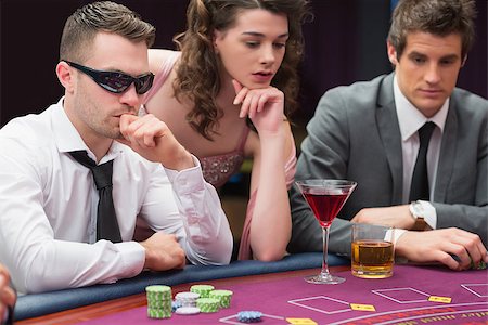 people sitting in casino - Men and woman sitting at poker table in casino Stock Photo - Budget Royalty-Free & Subscription, Code: 400-06801803